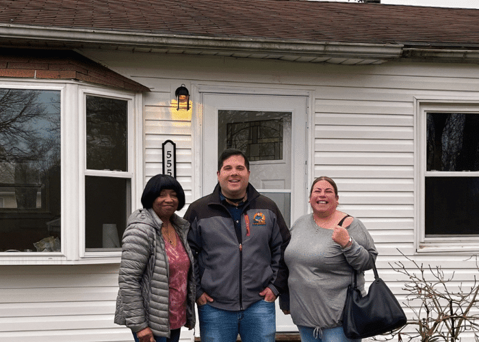 Mike Plactere with two sellers outside a Long Island house